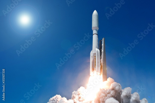 Take off space rocket on a background of blue sky and sun. Elements of this image were furnished by NASA