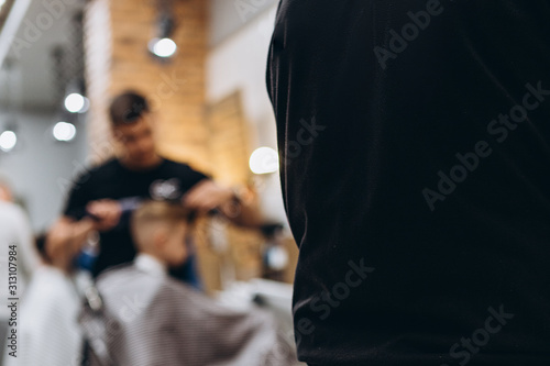 the interior of a modern hair salon for men where hairdressers work exclusively for men: haircuts, shaves and hair styling and beards, selective focus, noise effect