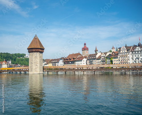 Beautiful view of history landmark The Chapel bridge on Europe style buildings and blue sky background, copy space