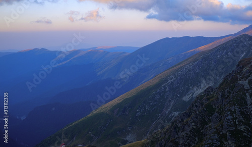 Sunrise on Fagaras high mountain ridge. Romanian mountain landscape with high peaks over 2200m photo