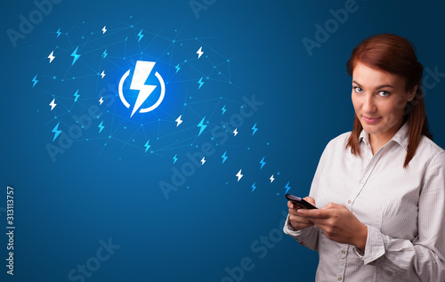 Young person using phone with power concept photo