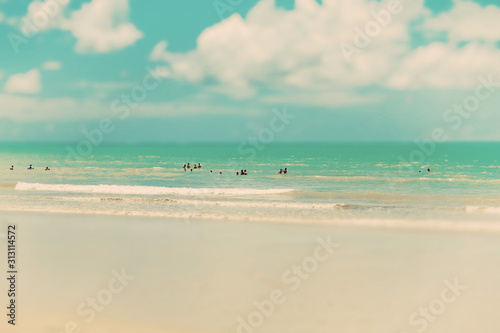 Tropical beach in Brazil with swimming people in the Atlantic Ocean