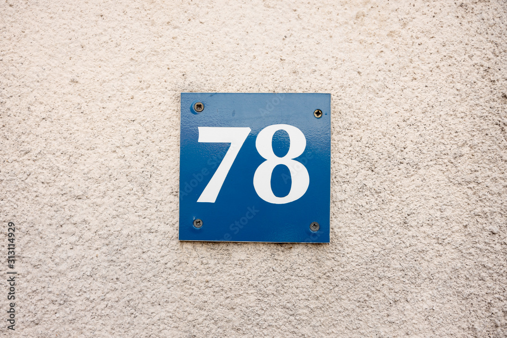 Number 78, seventy eight, street number sign on the wall Number 78, seventy eight, street number sign on the wall