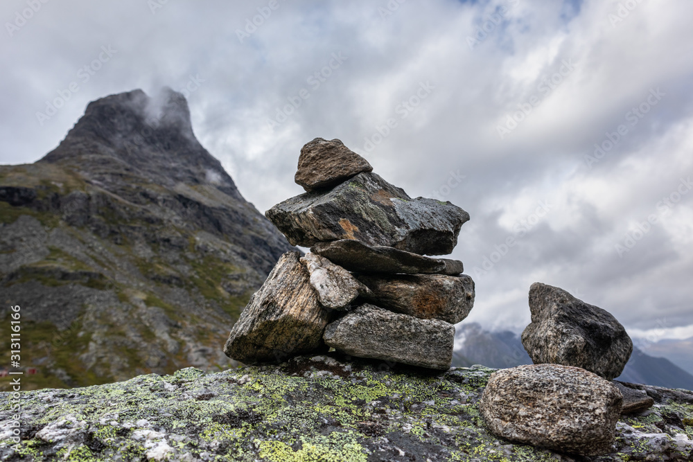 Troll rock pyramid on top of Trollstigen road. Stone cairn among a mountain landscape in Norway