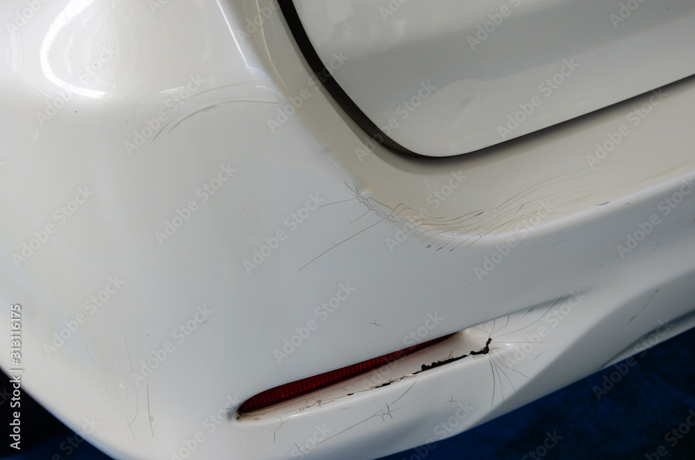 White car rear bumper cracks