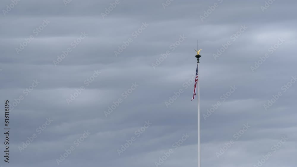American flag flutters in the wind in cloudy weather American flag flutters in the wind in cloudy weather