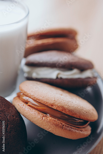 Close up Traditional chocolate and Pumpkin Whoopie pies made with vanilla cream cheese. Background for bakeries, cafes, restaurants photo