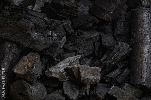 black coal background. charcoal woody black. lot of wood