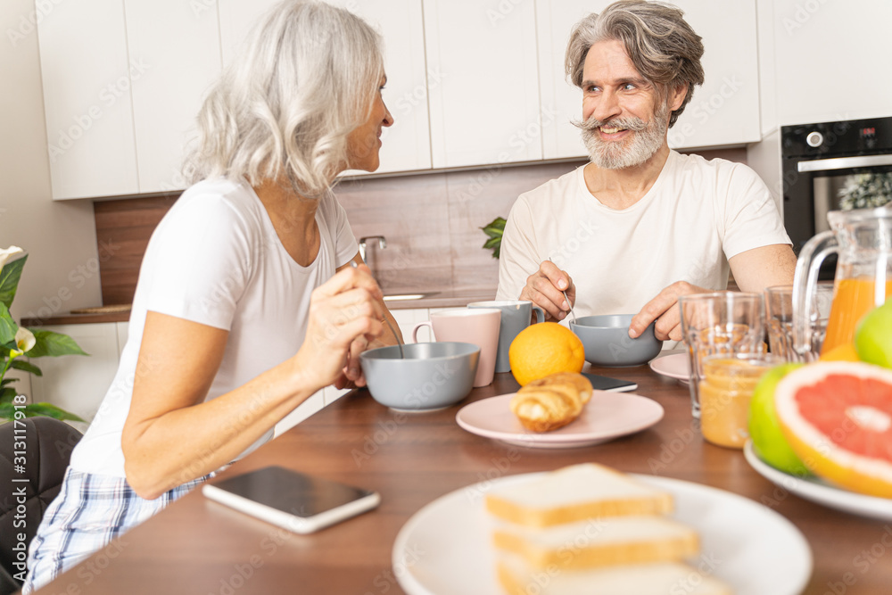 Happy husband having breakfast with his wife Happy husband having breakfast with his wife