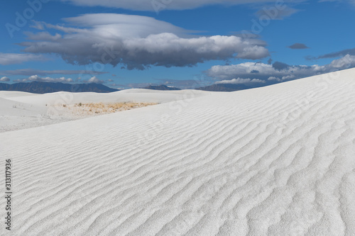 Lenticular cloud over white dunes at White Sands National Park in New Mexico