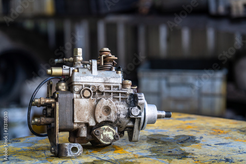 Diesel injection pump on mechanic working table   mechanical maintenance and repair background