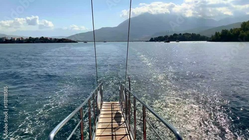 View from the stern of the ship on open sea with many islands. Summer vacation. Ocean view. Mountains. 4k video