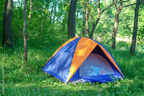 Tourist tent on the background of forest