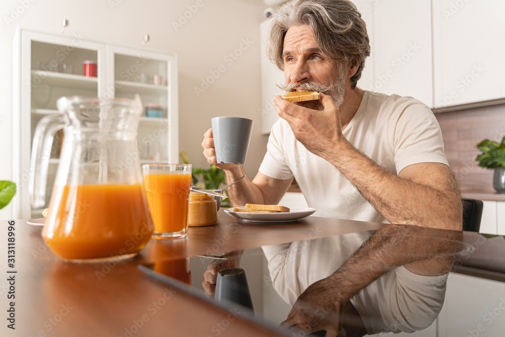 Serious man eating his peanut butter toast Serious man eating his peanut butter toast
