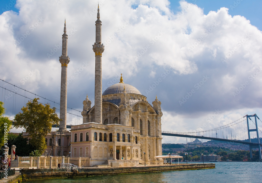 The Ortakoy Mosque, officially known as Buyuk Mecidiye Camii or the Grand Imperial Mosque of Sultan Abdulmecid in the Ortakoy district of Besiktas, Istanbul, Turkey. The Bosphorus Bridge can be seen i