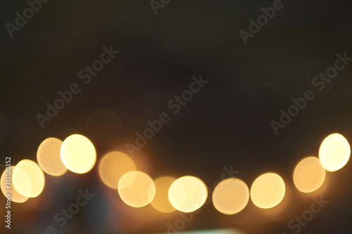 Blurry lights of garland on a dark background © Ekaterina Bokova