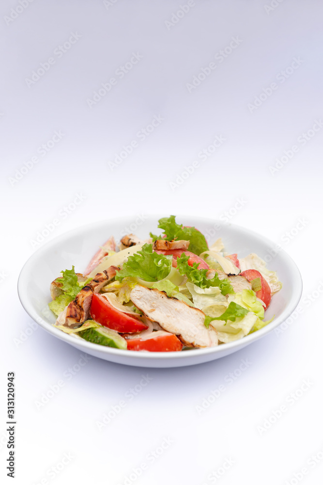 white deep plates with fresh salad ingredients mixed with sauce placed on isolated white background. A place for a menu, banner or advertisement white deep plates with fresh salad ingredients mixed with sauce placed on isolated white background. A place for a menu, banner or advertisement