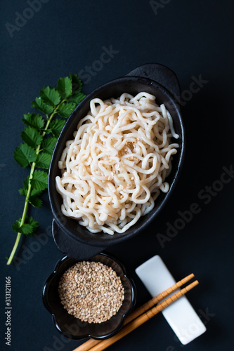 Healthy food concept organic Noodle or spaghetti Shirataki Konjac in black ceramic cup with copy space photo