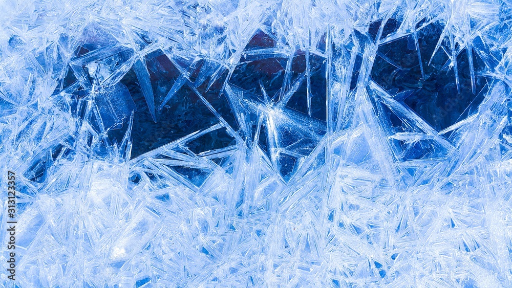 Winter icy blue background, the water of the river froze and there were beautiful patterns, shining under the sunlight, creating a winter mood, copy space for text. Winter icy blue background, the water of the river froze and there were beautiful patterns, shining under the sunlight, creating a winter mood, copy space for text.