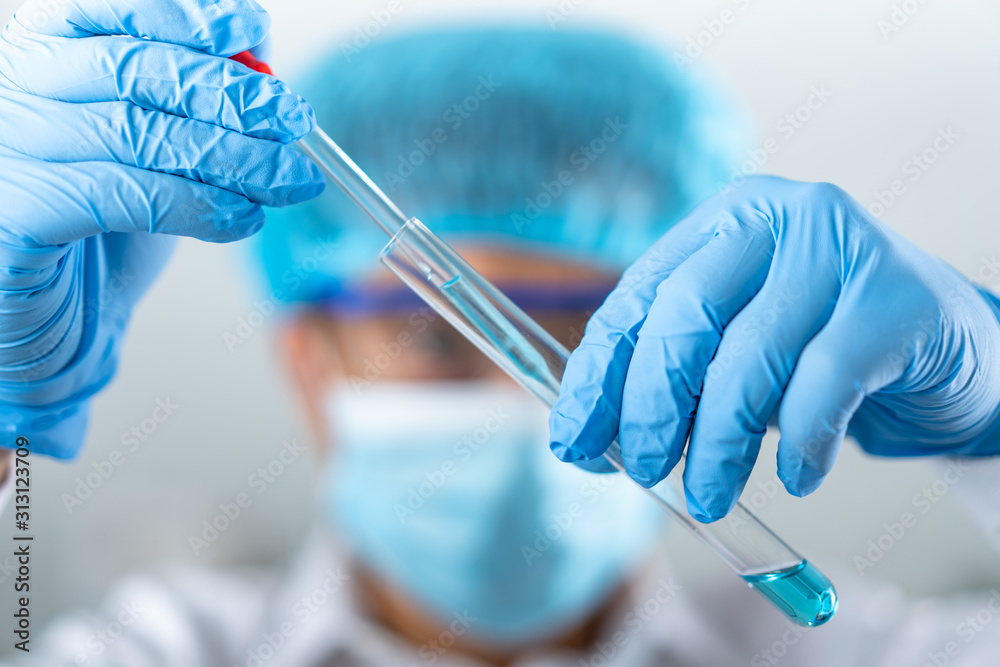 man holding test tube with fluid, making laboratory research man holding test tube with fluid, making laboratory research