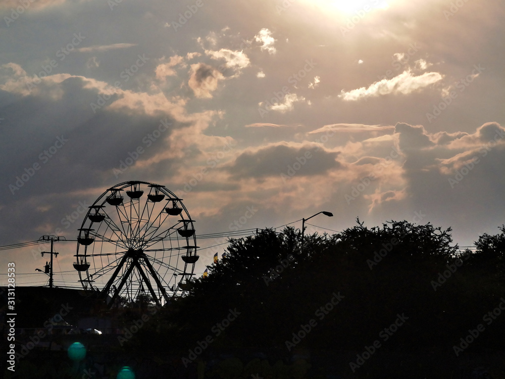 Ferris wheel silhouette in sunset