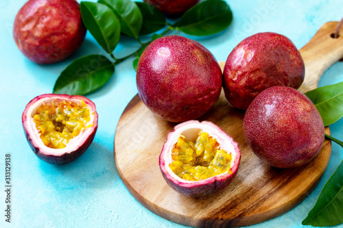 Passion Fruit. Ripe juicy tropical summer seasonal fruits on a blue stone countertop.