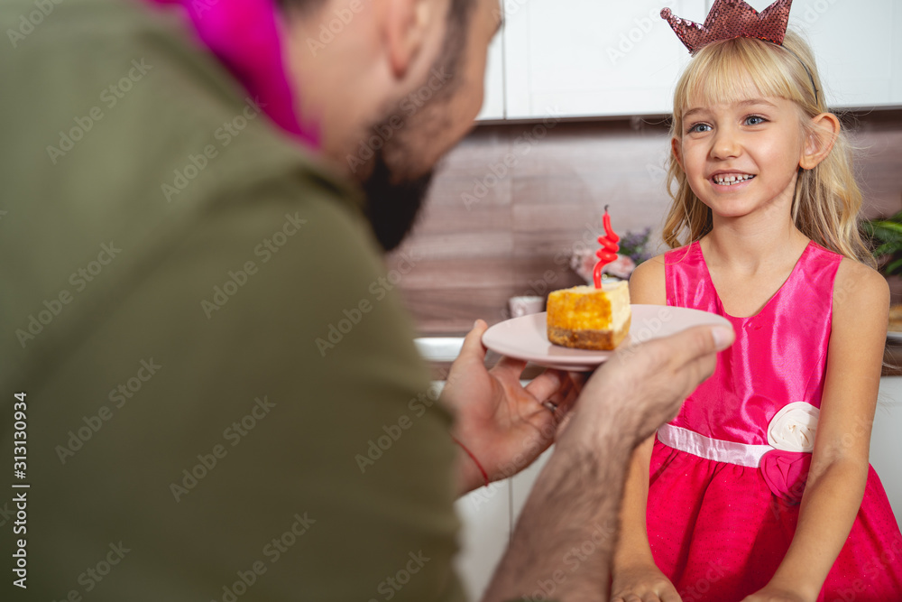 Happy little girl celebrating birthday with her father Happy little girl celebrating birthday with her father