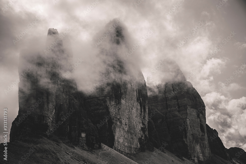 View of the three peaks of Lavaredo Veiled by clouds, from the Locatelli refuge