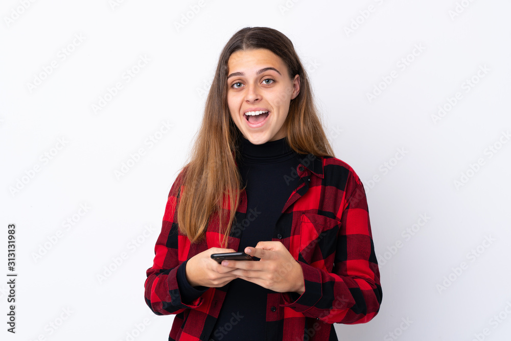Teenager girl over isolated white background surprised and sending a message Teenager girl over isolated white background surprised and sending a message