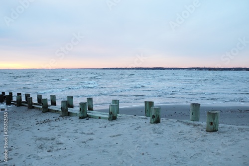 New England coastal sandy shoreline beach at sunset in winter