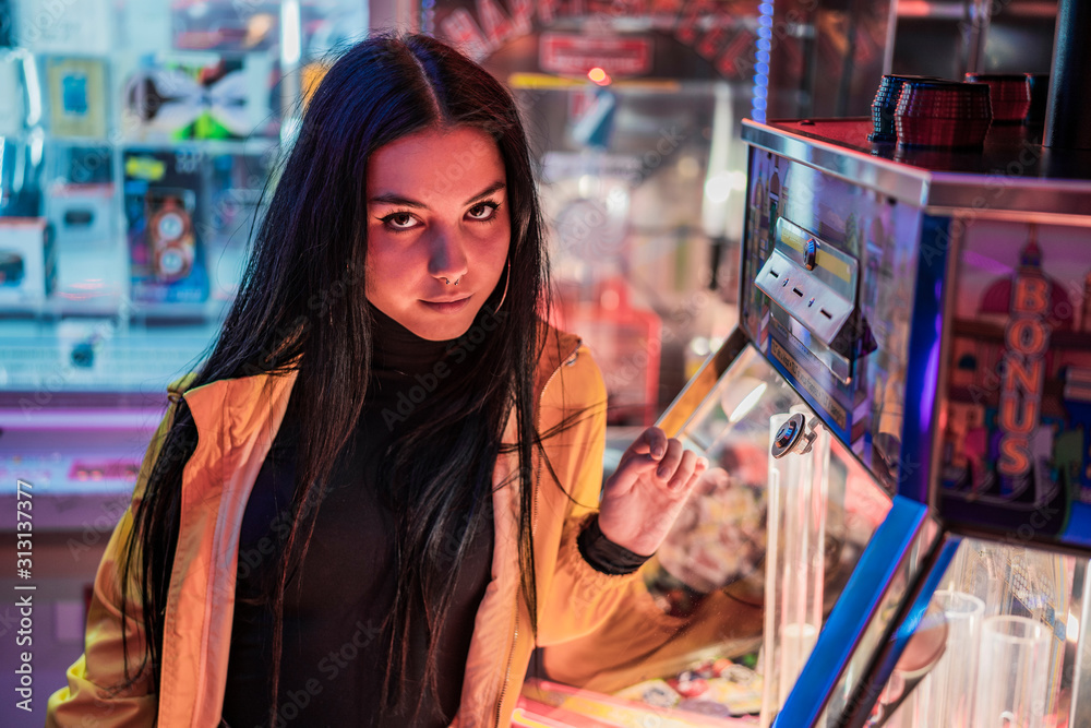 girl looking at camera in amusement park at night