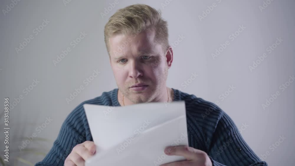 Close-up of dissatisfied Caucasian man looking through documents and throwing them away. Annoyed businessman having problems. Stress, depression, hardworking. Close-up of dissatisfied Caucasian man looking through documents and throwing them away. Annoyed businessman having problems. Stress, depression, hardworking.