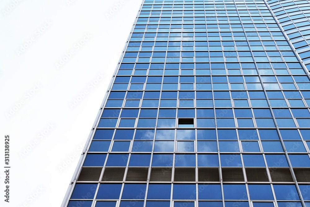 Abstract image of looking up at modern glass and concrete building. Architectural exterior detail of office building. Abstract image of looking up at modern glass and concrete building. Architectural exterior detail of office building.