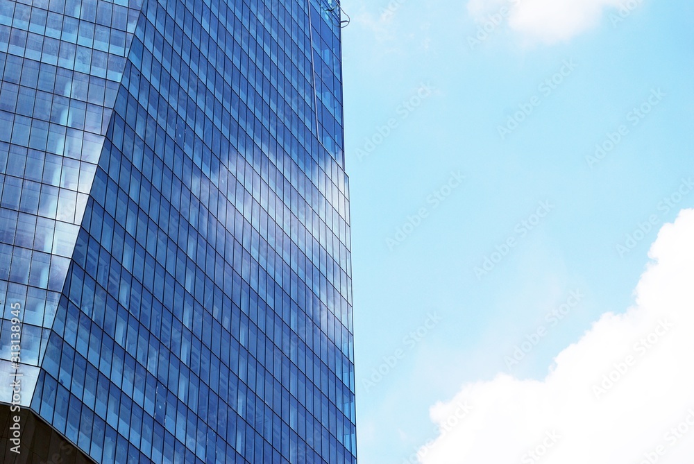 Abstract image of looking up at modern glass and concrete building. Architectural exterior detail of office building. Abstract image of looking up at modern glass and concrete building. Architectural exterior detail of office building.