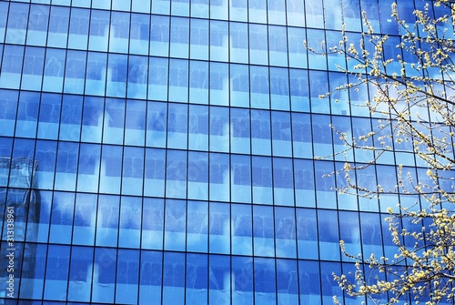 Abstract image of looking up at modern glass and concrete building. Architectural exterior detail of office building. 