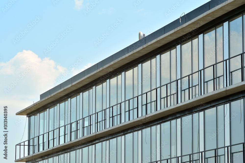 Abstract image of looking up at modern glass and concrete building. Architectural exterior detail of office building. Abstract image of looking up at modern glass and concrete building. Architectural exterior detail of office building.