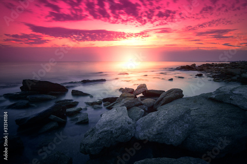 Wild rocky beach at dawn. Long exposure