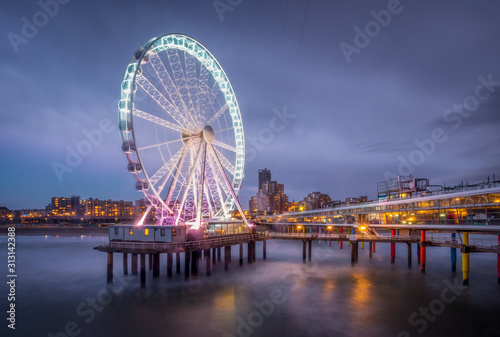 Scheveningen, the Netherlands - 10 March 2019: Long exposure image of the ferris wheel on the pier of Scheveningen, The Hague.