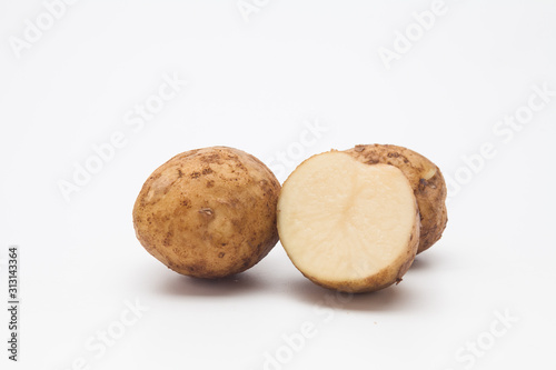 Sliced raw potatoes on a white background