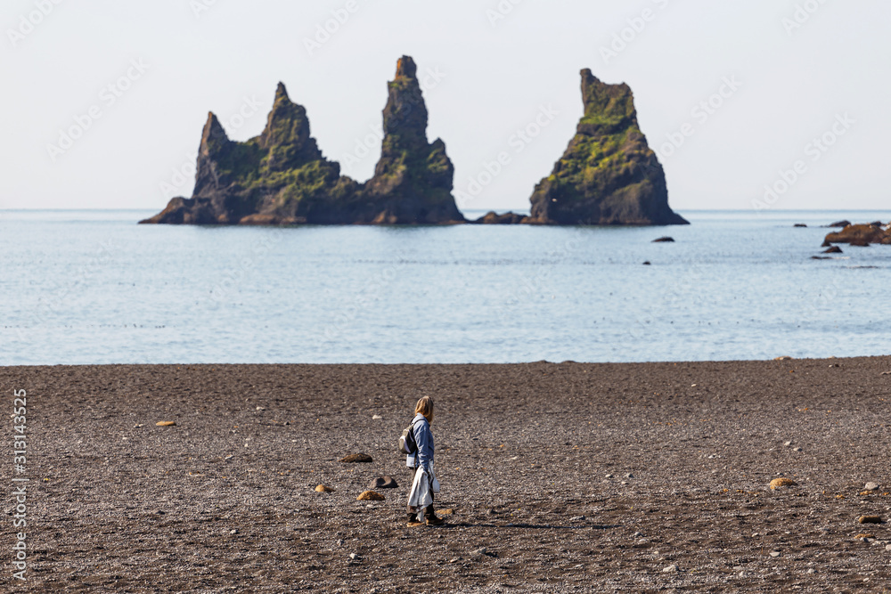 Woman Walking Along the Beach Looking at the Prominent Sea Stacks in ...