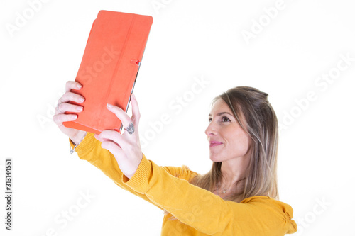 Young woman taking a selfie with computer tablet camera