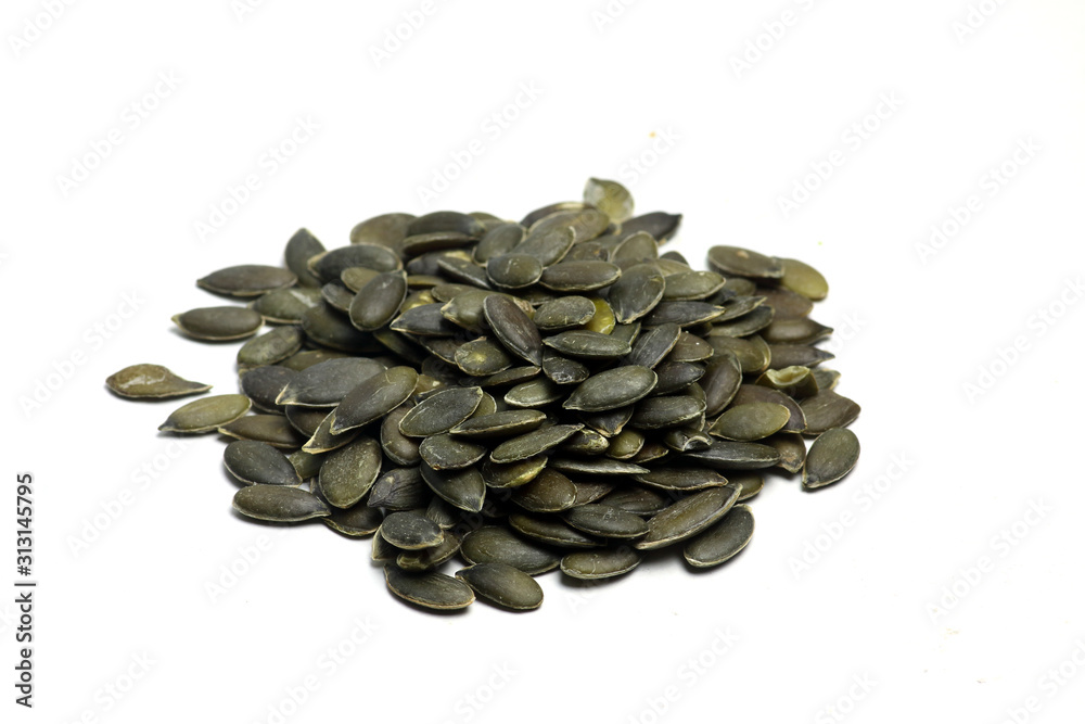 a pile of pumpkin seeds isolated on white background flat lay. Horizontal image a pile of pumpkin seeds isolated on white background flat lay. Horizontal image