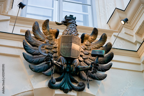 Coat of arms of Austria as Eagle bronze statue at Austrian Federal Chancellery, or Bundeskanzleramt, or BKA on Ballhausplatz Square in Innere Stadt in Old city center in Vienna in Austria photo