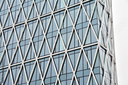 Abstract image of looking up at modern glass and concrete building. Architectural exterior detail of office building. 