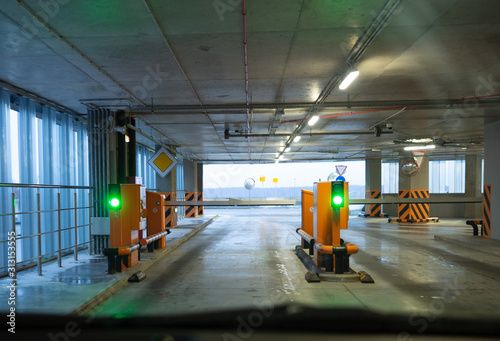 Barrier in the airport parking. Green traffic light is on. 