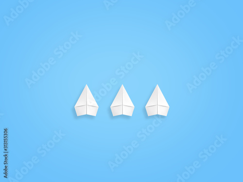 New trends concept. One red paper plane followed by group of white ones on blue background, copy space © gorynvd