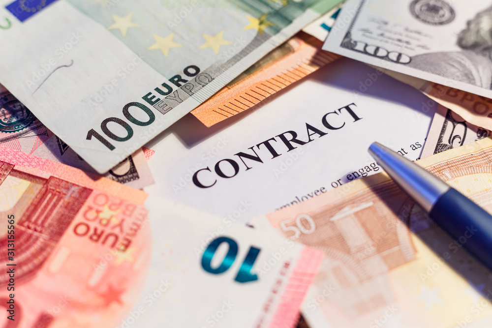 stack hundreds dollars on contract document background stack hundreds dollars on contract document background