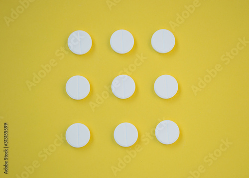 Close-up of round white pills, painkiller, health concept, pharmaceutical tablets