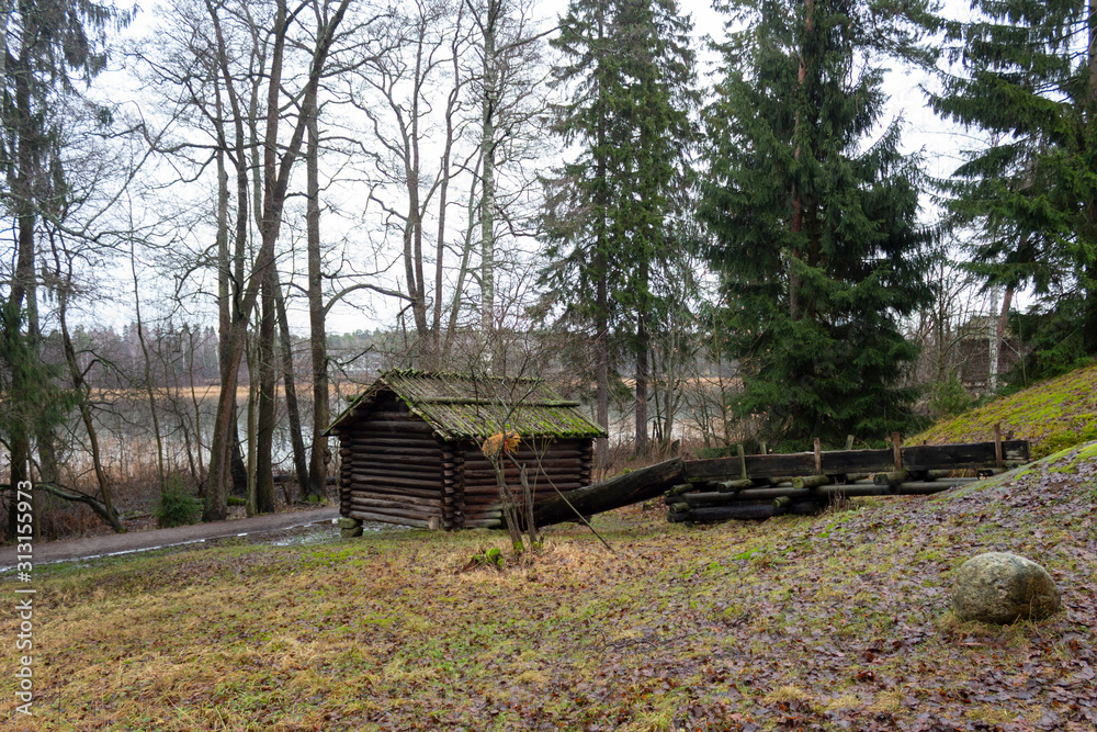 Ancient authentic wooden house of the 16th century in a forest on the island of Seurasaari in Helsinki, Finland, a cloudy day in late autumn. Ancient authentic wooden house of the 16th century in a forest on the island of Seurasaari in Helsinki, Finland, a cloudy day in late autumn.