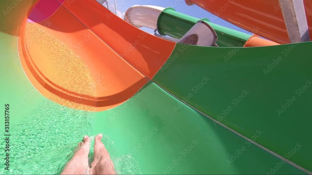 Man having fun on a water slide. Cool people having fun on the water